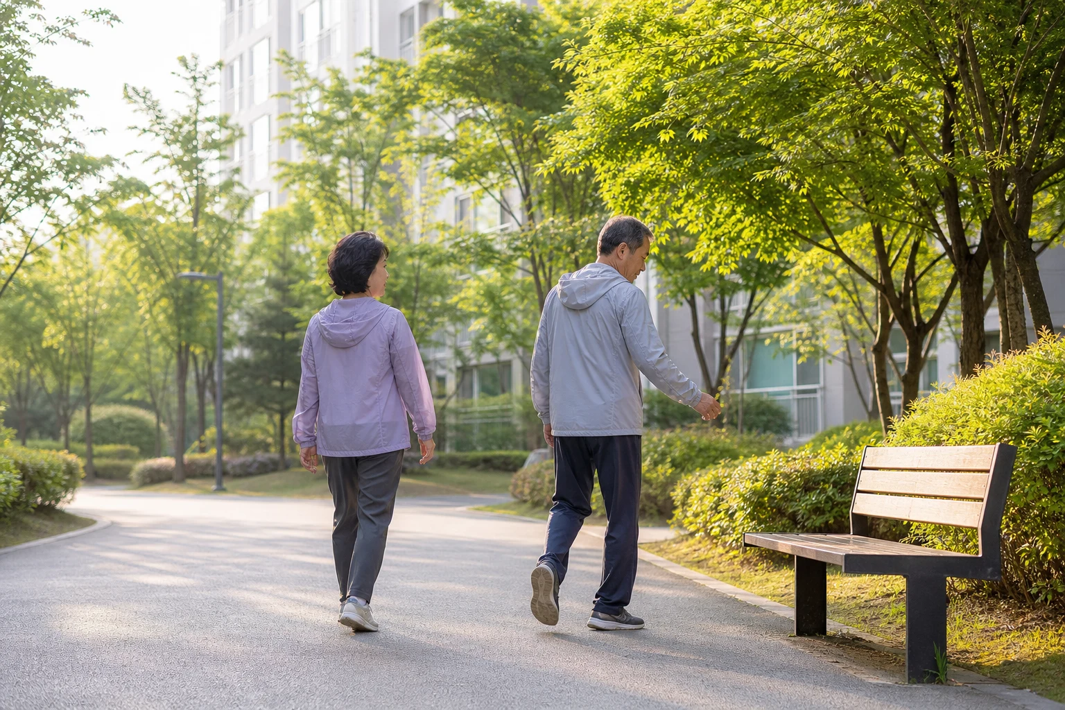 아파트 산책로에서 천천히 걷다가 벤치 쪽으로 향하는 척추관협착증 초기증상 자가 점검 장면